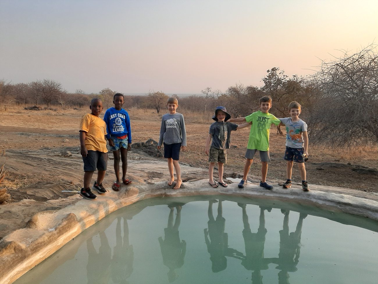Grade 2 pupils at the waterhole at Kushiya Farm at sunrise